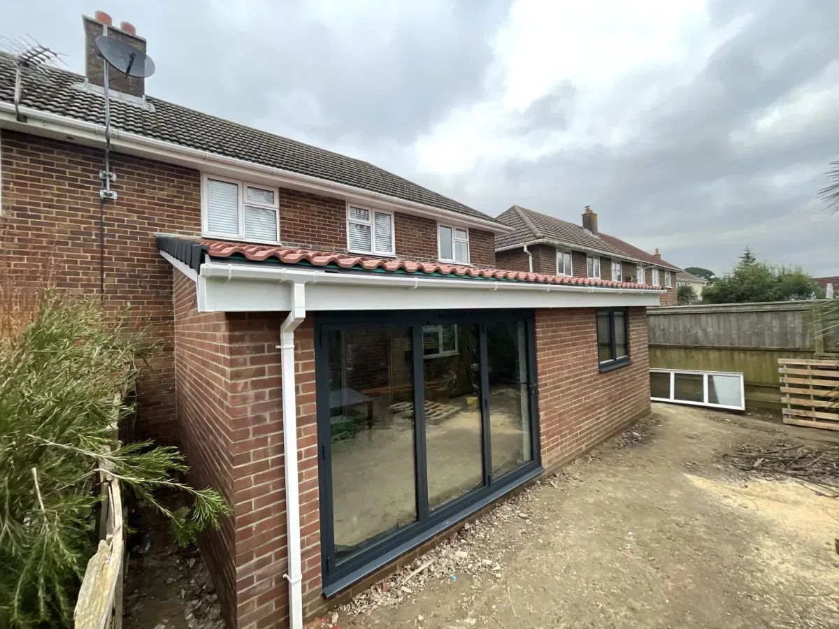 Single-storey rear extension with anthracite bi-fold doors and a tiled roof in Bournemouth